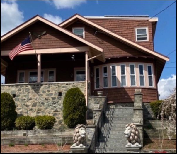Brown craftsman home with stone foundation